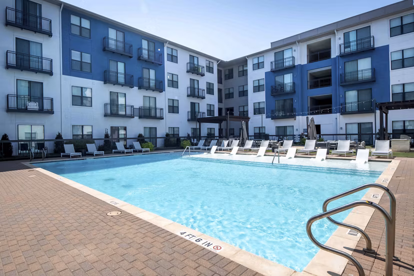 Outdoor lap pool at Broadstone on Trinity Apartments with lounge seating and modern design, ideal for relaxation and recreation