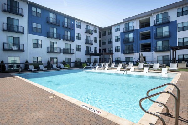 Outdoor lap pool at Broadstone on Trinity Apartments with lounge seating and modern design, ideal for relaxation and recreation
