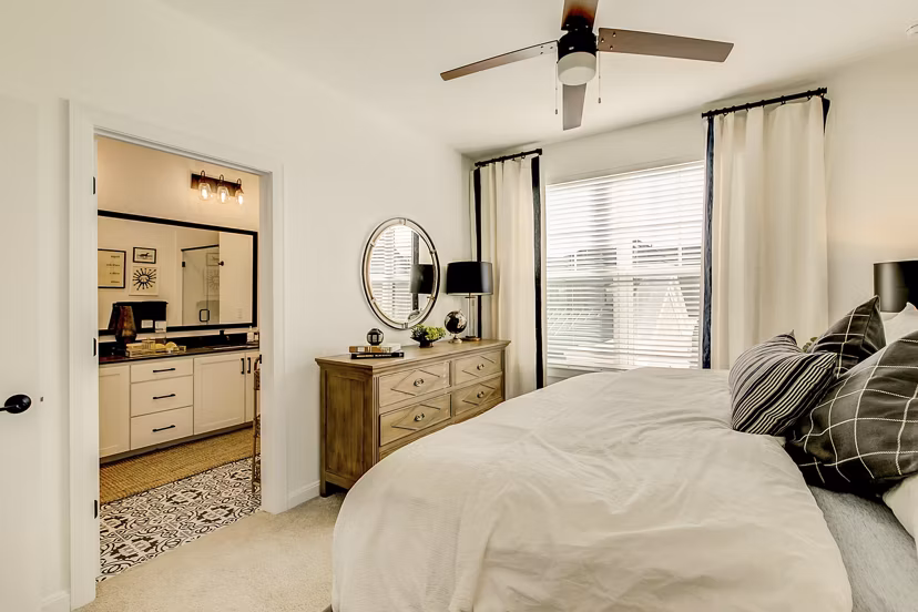 Cozy bedroom with modern furnishings at Elan Inwood Apartments, offering luxury living with comfort and style