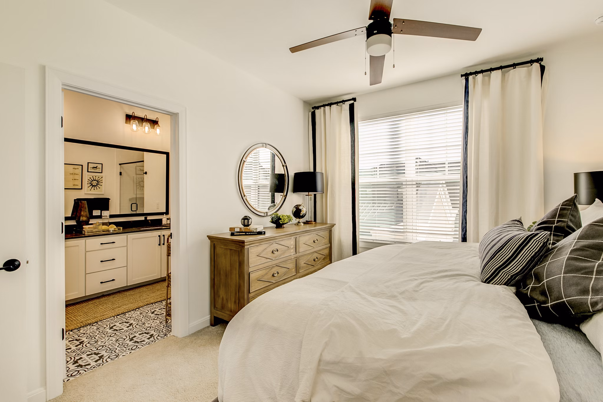 Cozy bedroom with modern furnishings at Elan Inwood Apartments, offering luxury living with comfort and style