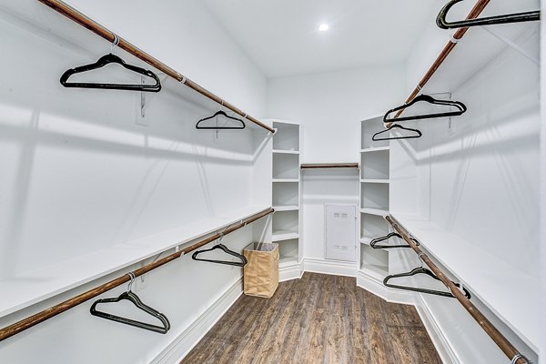 Walk-in bedroom closet with custom shelving at Elan Inwood Apartments
