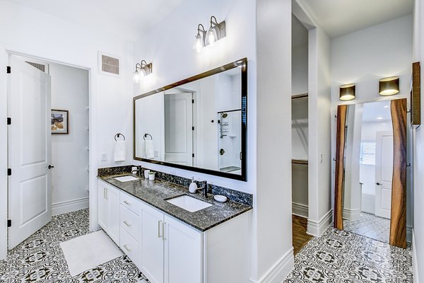 Modern bathroom with sleek fixtures and granite countertops at Elan Inwood Apartments