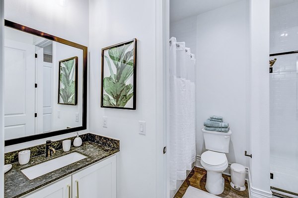 Modern bathroom with sleek fixtures and marble tile at Elan Inwood Apartments, Dallas Luxury amenities enhance your living experience