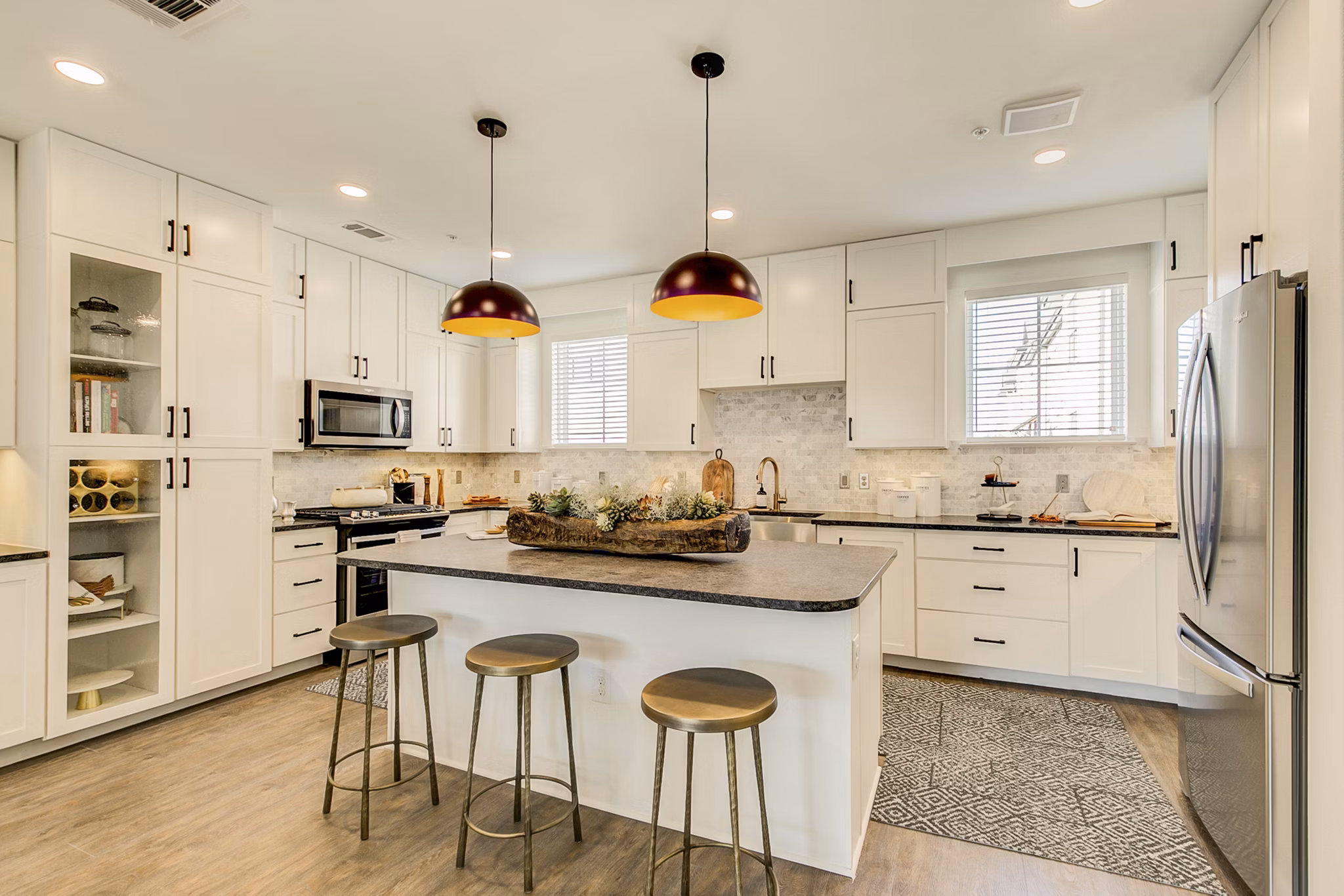 Modern kitchen with stainless steel appliances and granite countertops at Elan Inwood Apartments Perfect for cooking enthusiasts and hosting guests