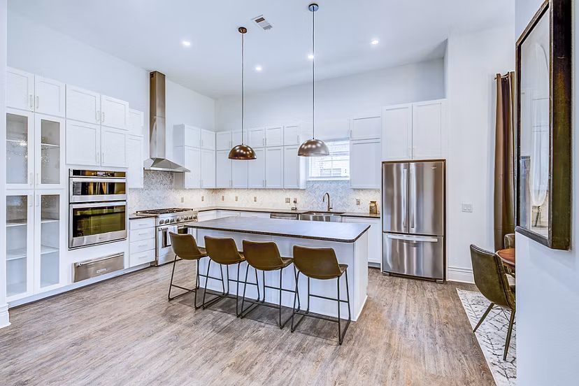 Modern kitchen with stainless steel appliances and granite countertops in Elan Inwood Apartments