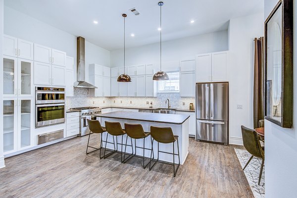 Modern kitchen with stainless steel appliances and granite countertops in Elan Inwood Apartments