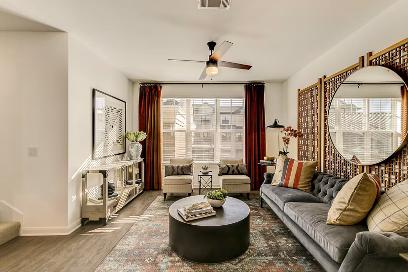 Modern living room with stylish furniture and large windows at Elan Inwood Apartments