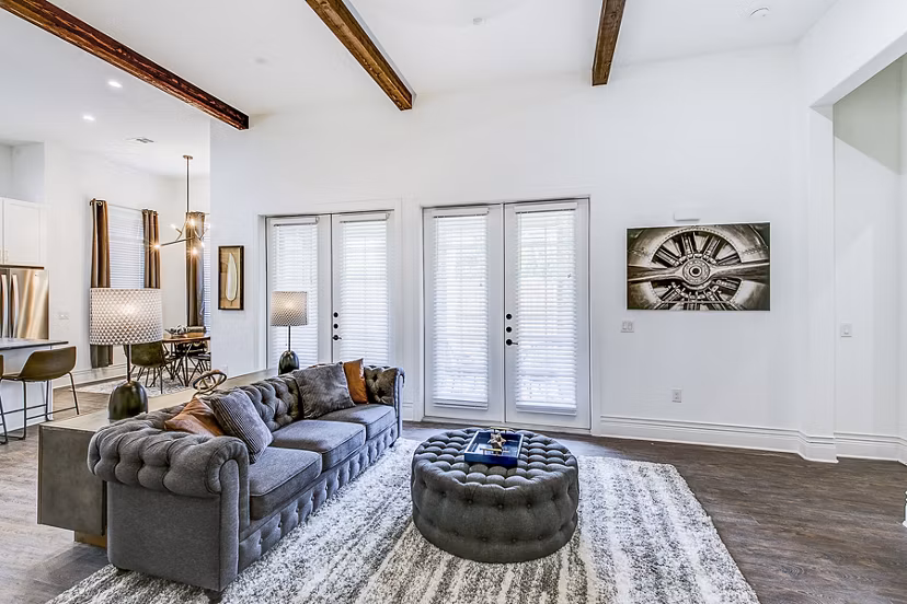 Spacious living room featuring modern decor and large windows at Elan Inwood Apartments