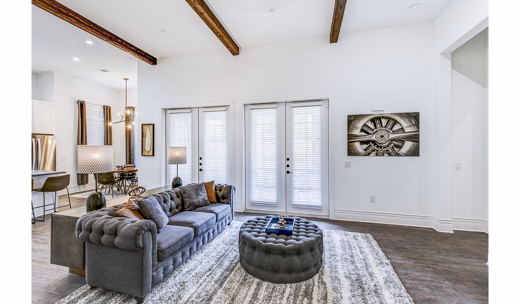 Spacious living room featuring modern decor and large windows at Elan Inwood Apartments
