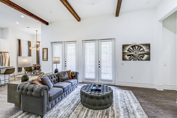 Spacious living room featuring modern decor and large windows at Elan Inwood Apartments
