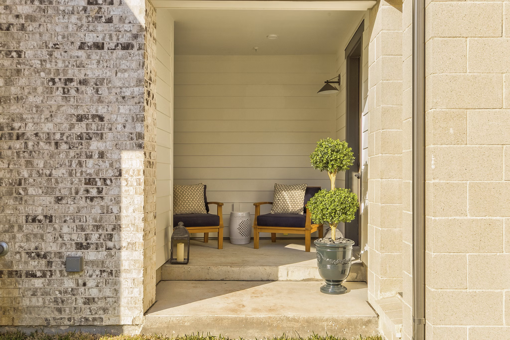 Spacious outdoor patio area with modern seating at Elan Inwood Apartments, offering residents a comfortable space to relax and entertain