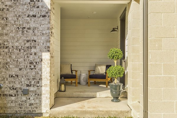 Spacious outdoor patio area with modern seating at Elan Inwood Apartments, offering residents a comfortable space to relax and entertain
