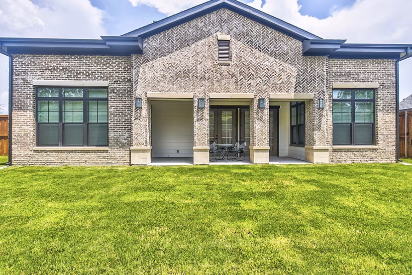Backyard patio featuring cozy seating and lush landscaping at Elan Inwood Apartments