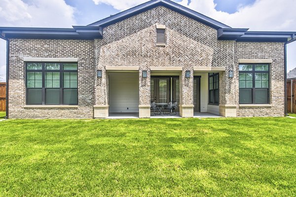 Backyard patio featuring cozy seating and lush landscaping at Elan Inwood Apartments