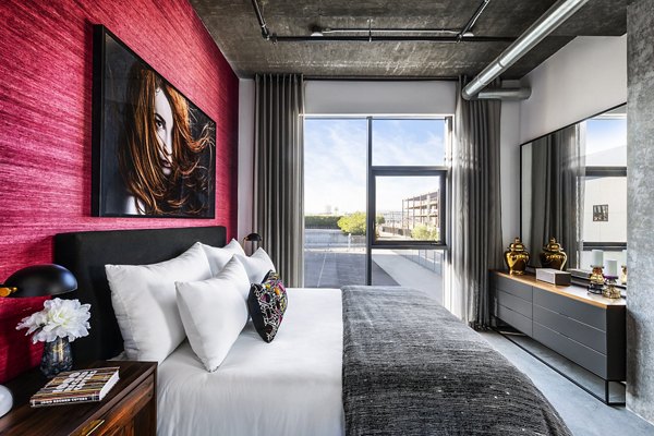 Cozy bedroom with modern decor at AMP Lofts Apartments