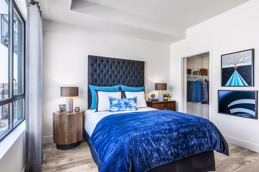 Cozy bedroom with minimalist decor at AMP Lofts Apartments in Los Angeles
