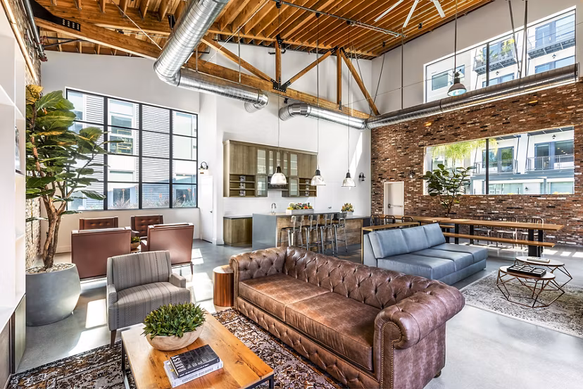 Clubhouse lobby with modern decor and seating options at AMP Lofts Apartments