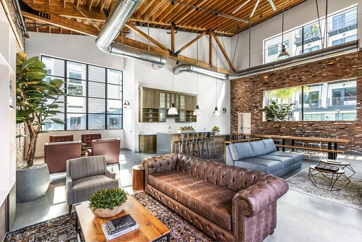 Clubhouse lobby with modern decor and seating options at AMP Lofts Apartments