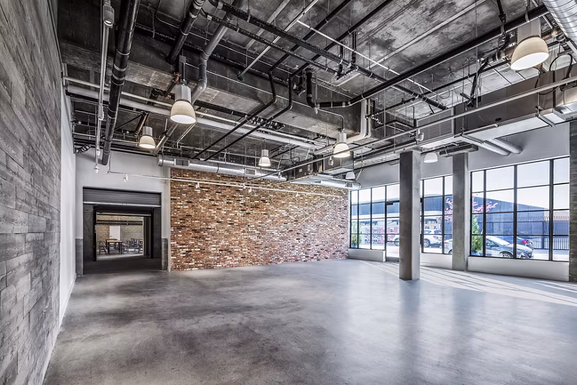 Clubhouse event space with modern seating and lighting at AMP Lofts Apartments for community gatherings and social events