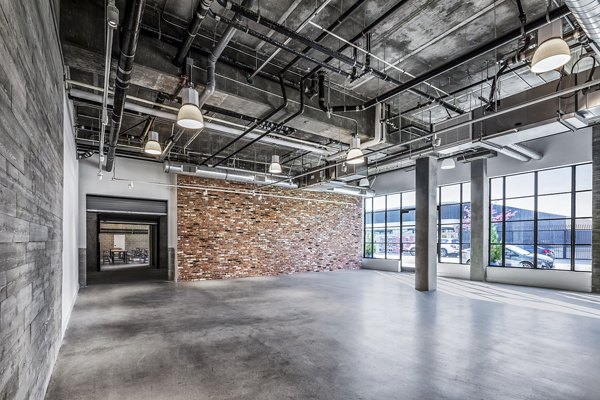 Clubhouse event space with modern seating and lighting at AMP Lofts Apartments for community gatherings and social events