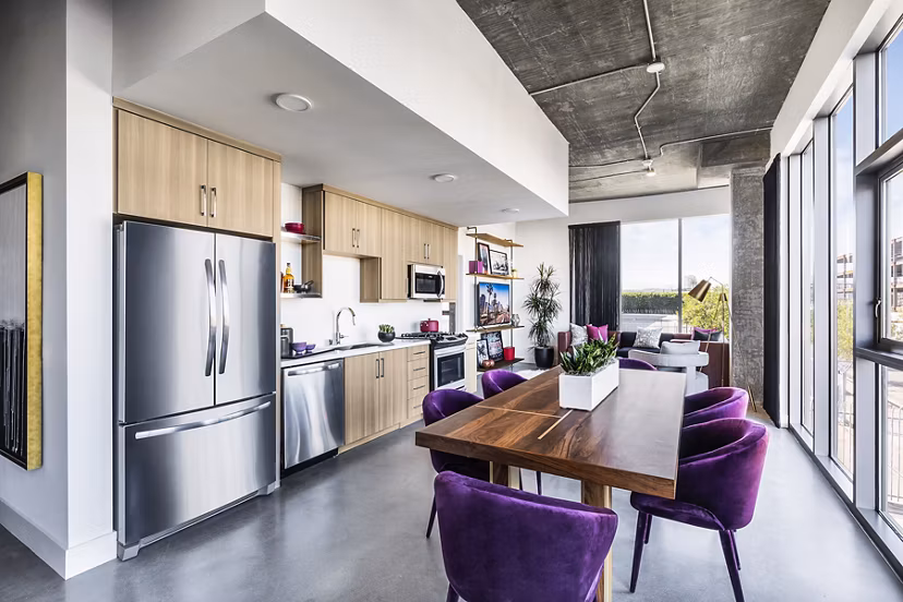 Dining room with modern furniture at AMP Lofts Apartments featuring sleek design and open layout