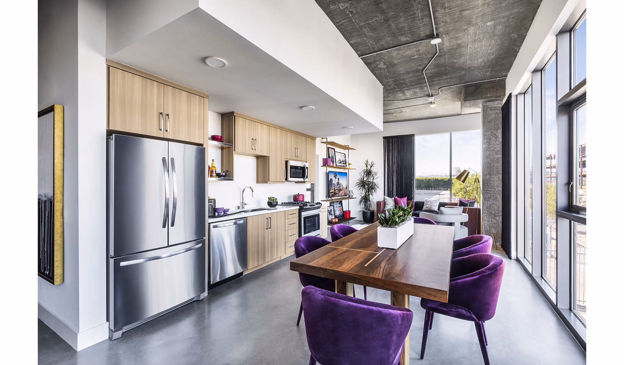 Dining room with modern furniture at AMP Lofts Apartments featuring sleek design and open layout