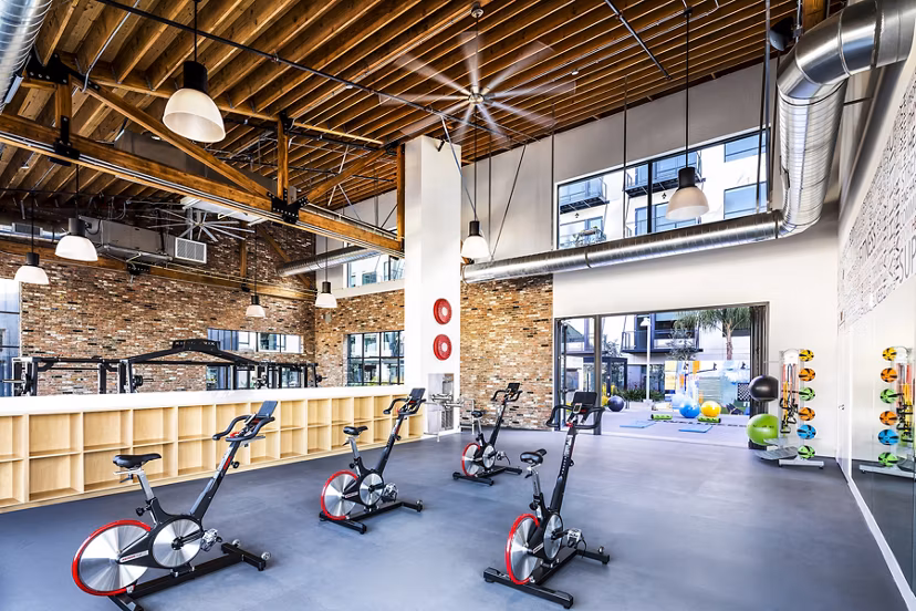 Bright yoga/spin studio with modern equipment at AMP Lofts Apartments, offering a vibrant fitness experience