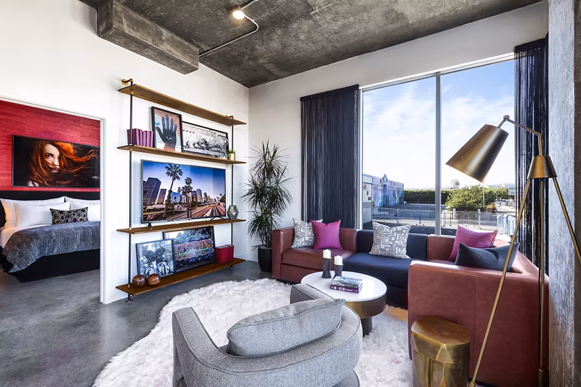 Spacious living room with modern decor in AMP Lofts Apartments, offering luxury living in a vibrant community