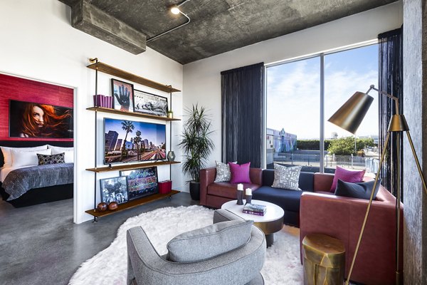 Spacious living room with modern decor in AMP Lofts Apartments, offering luxury living in a vibrant community