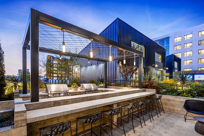 Outdoor grill area with modern appliances at AMP Lofts Apartments