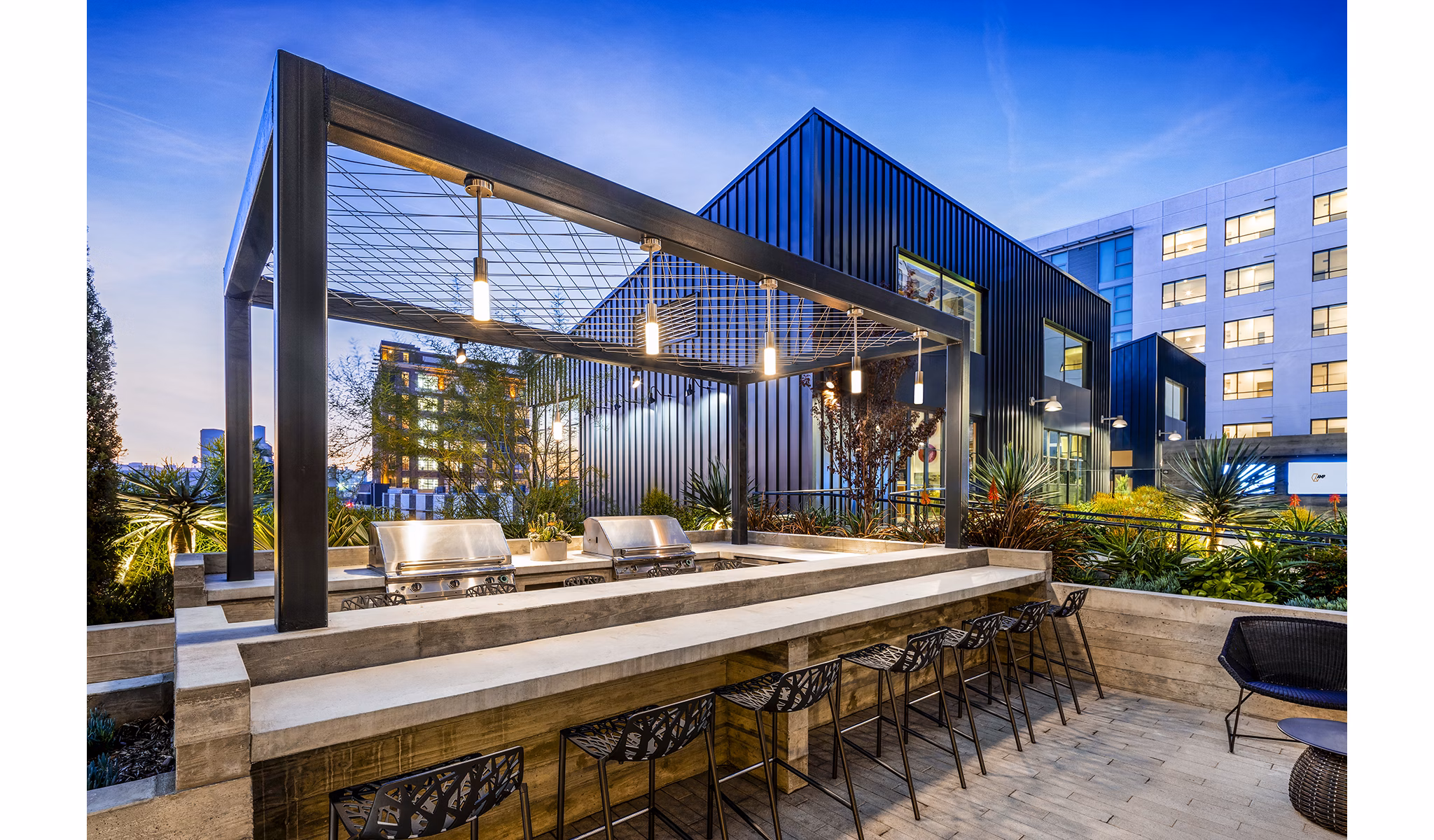 Outdoor grill area with modern appliances at AMP Lofts Apartments