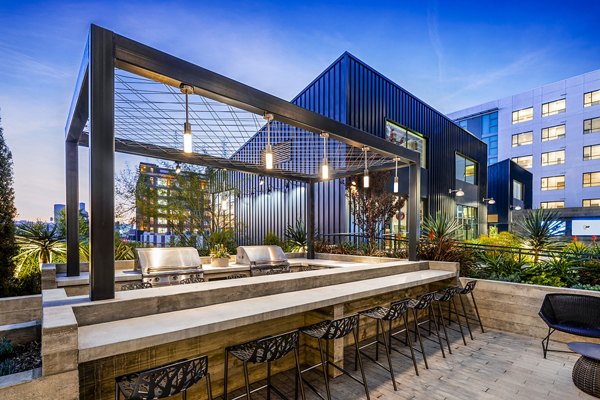 Outdoor grill area with modern appliances at AMP Lofts Apartments