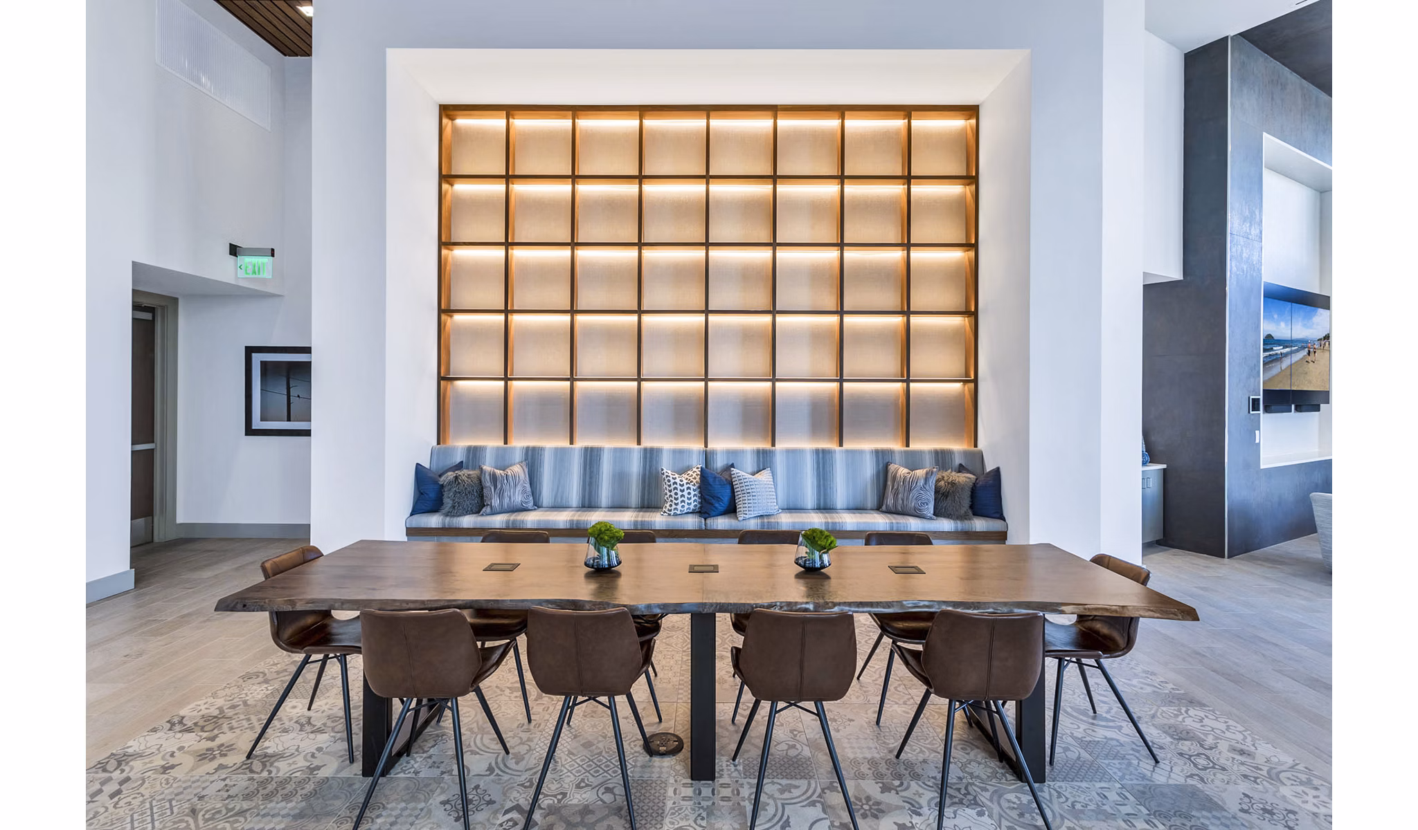 Stylish meeting room with sleek wooden table and cushioned seating at Parq on Speer Apartments in Denver Perfect for coworking or gatherings