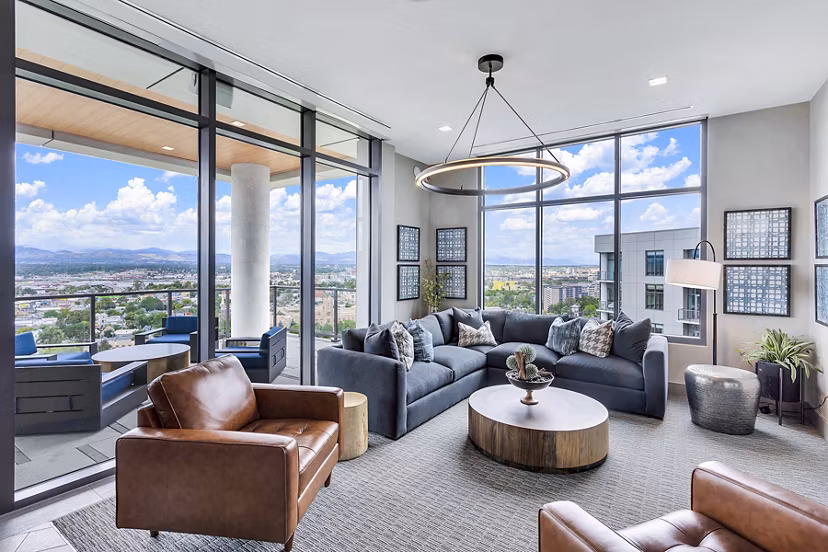 Parq on Speer Apartments: Spacious living room with large windows offering city view, luxury apartments by Greystar