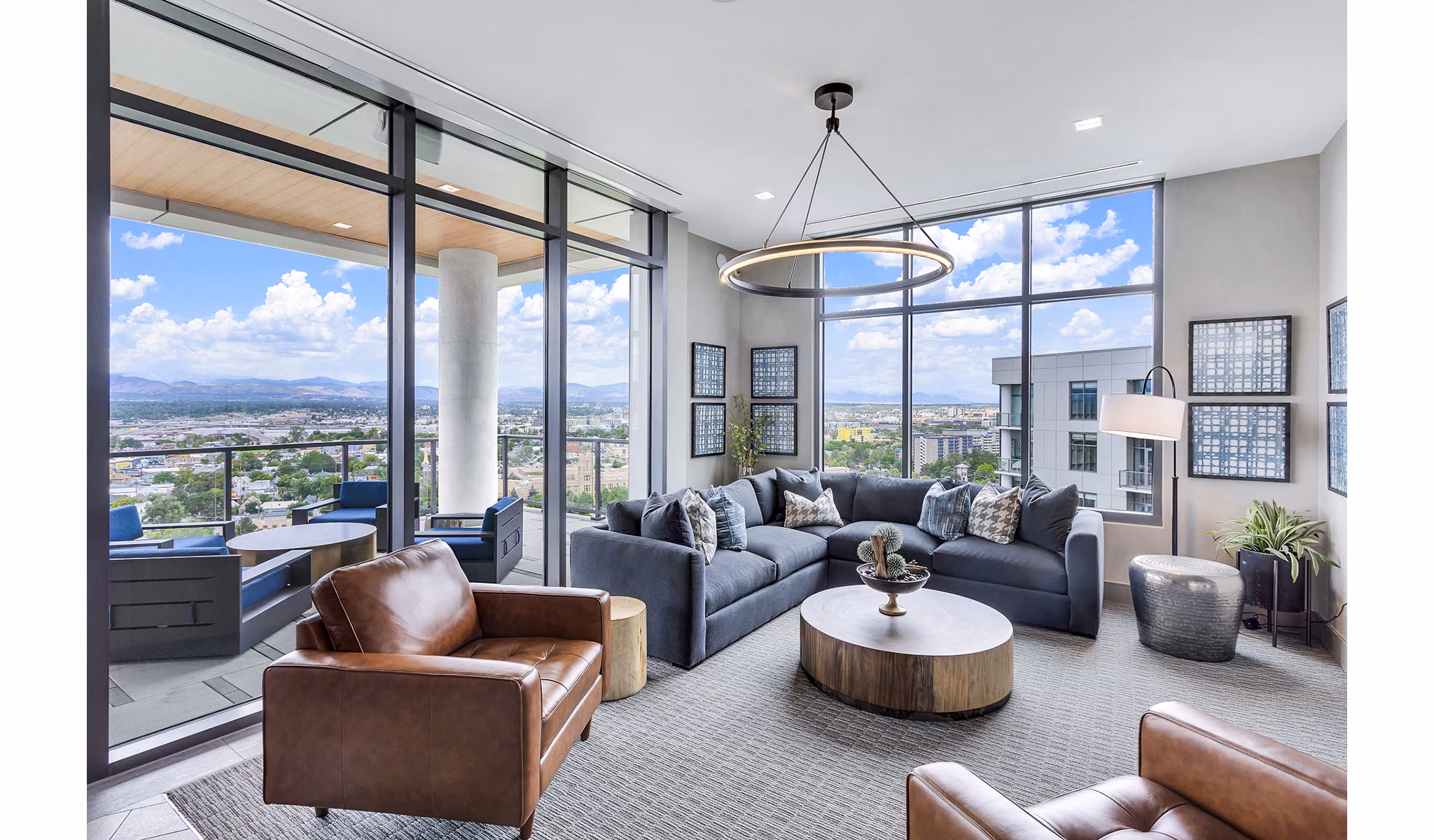 Parq on Speer Apartments: Spacious living room with large windows offering city view, luxury apartments by Greystar