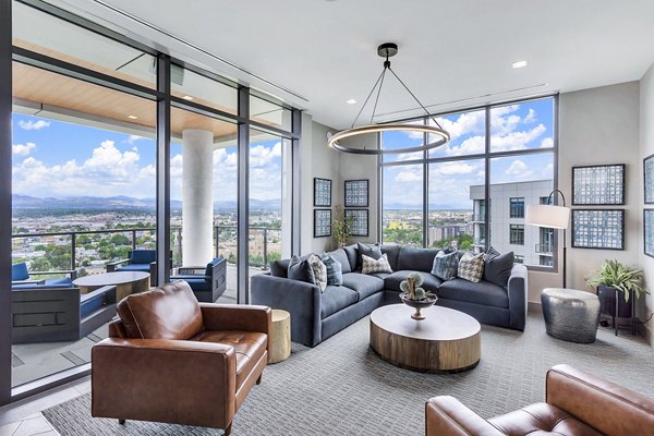 Parq on Speer Apartments: Spacious living room with large windows offering city view, luxury apartments by Greystar