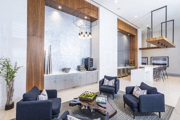 Spacious lobby with seating, wooden accents, and high ceilings at Parq on Speer luxury apartments in Denver