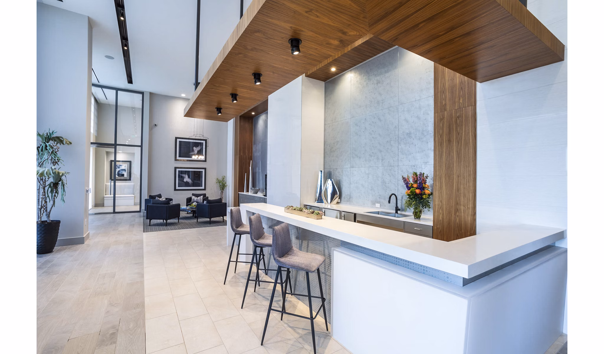 Parq on Speer Apartments: Sleek lobby with bar seating, high ceilings, and contemporary decor in luxury Denver living space