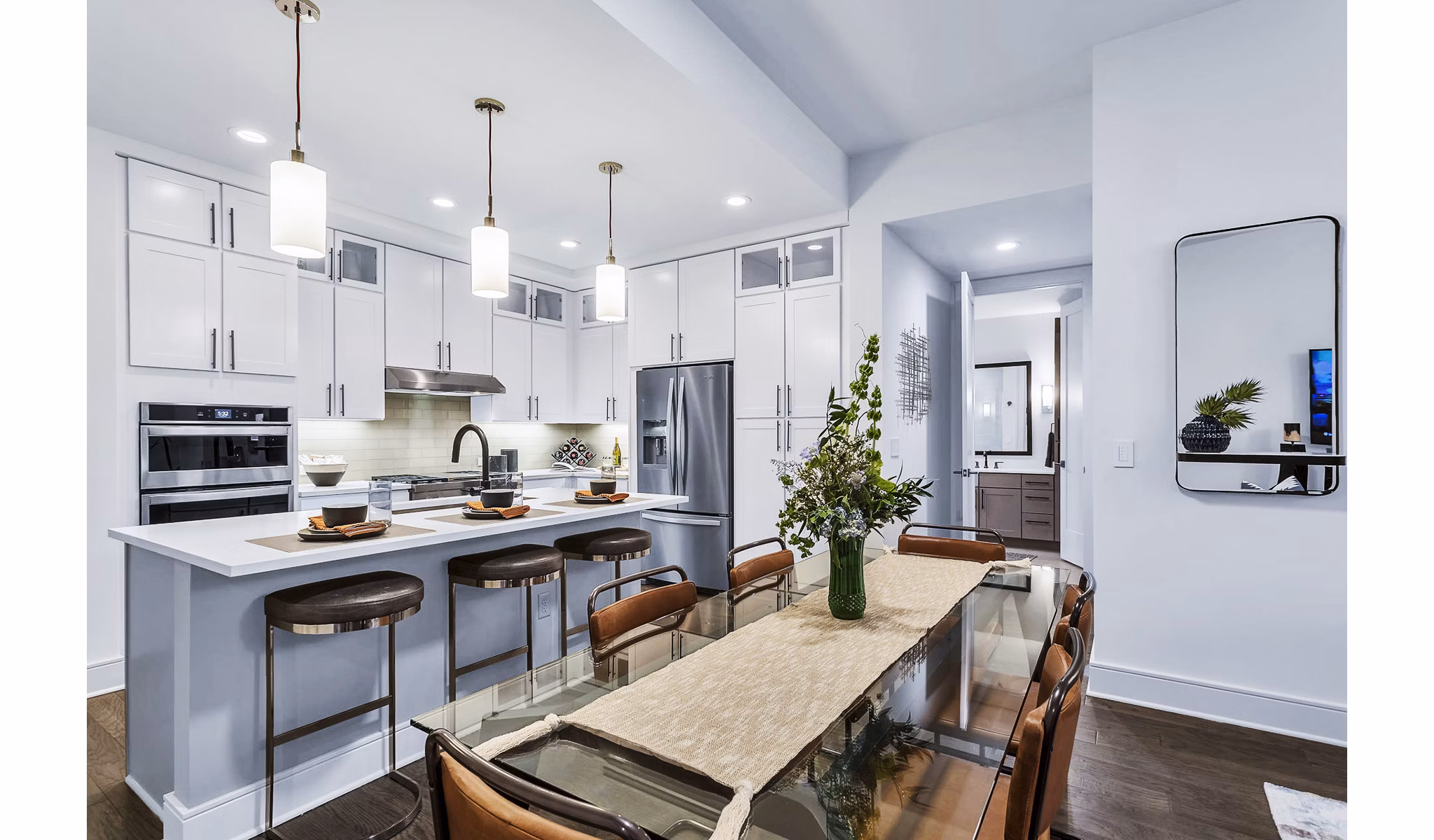Sleek kitchen with white cabinets and island at Parq on Speer luxury apartments, designed for modern living and culinary enthusiasts in urban settings