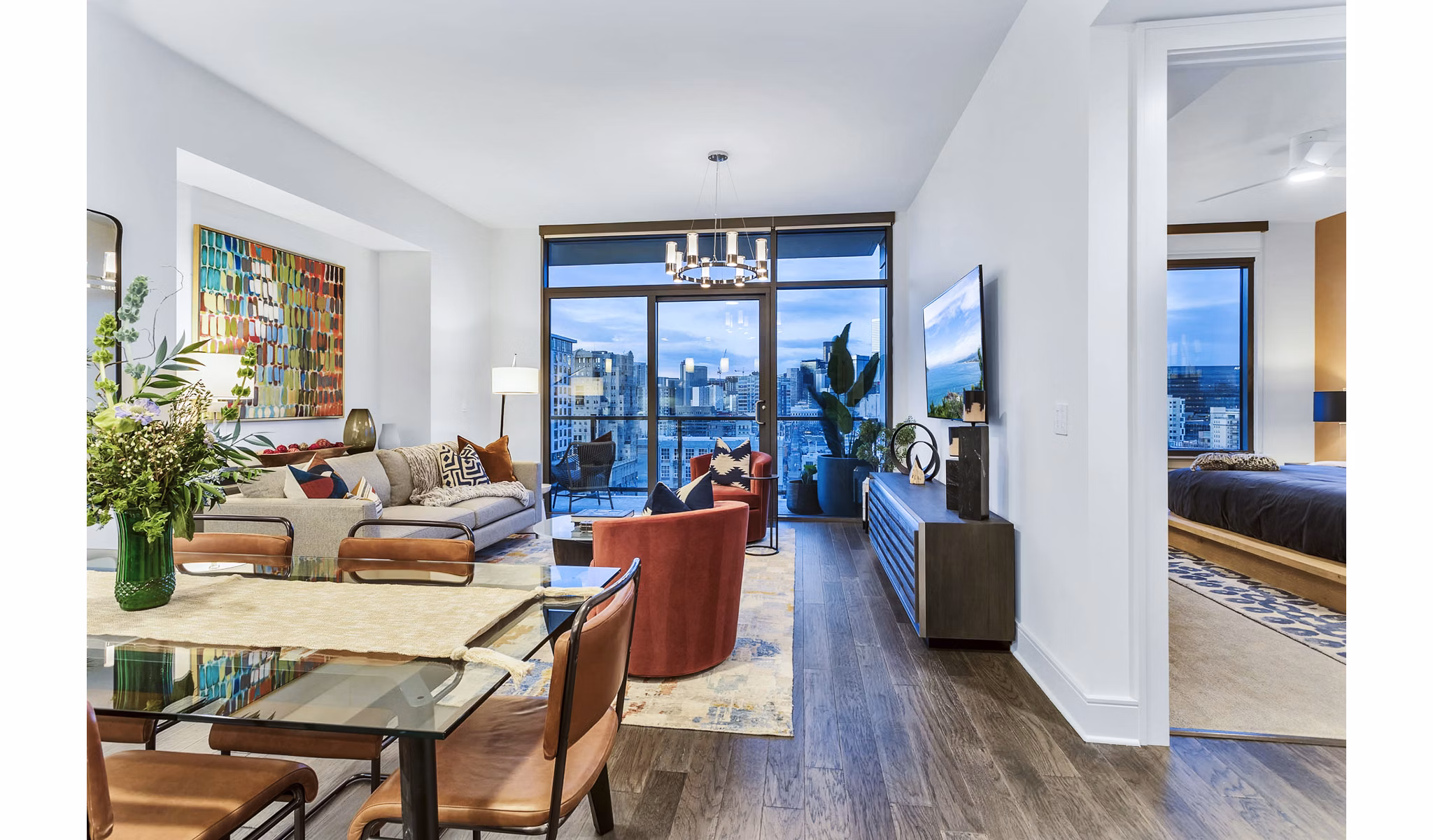 Stylish living room and bedroom with city views at Parq on Speer luxury apartments in Denver