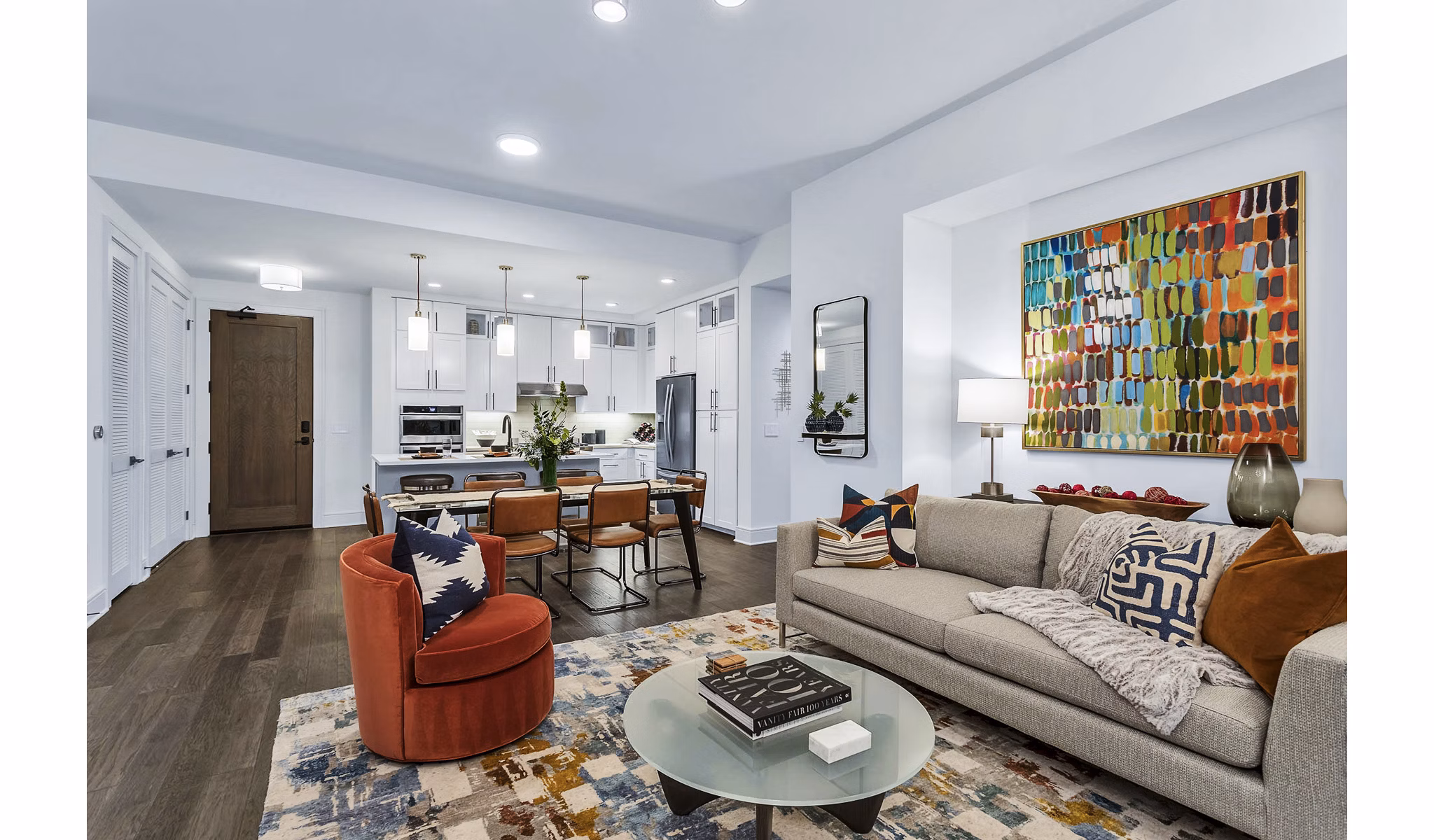 Open-concept living room and kitchen with colorful decor at Parq on Speer luxury apartments in Denver