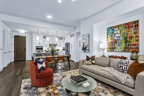 Open-concept living room and kitchen with colorful decor at Parq on Speer luxury apartments in Denver