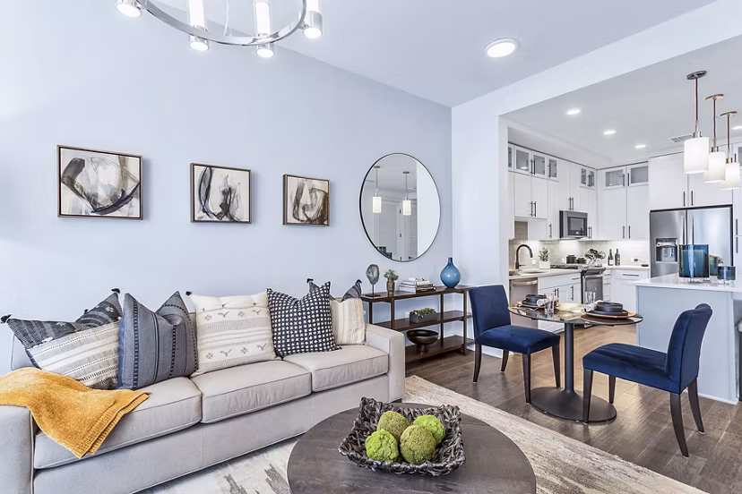 Stylish living room with chic sofa, dining area, and modern kitchen at Parq on Speer Apartments, luxury rentals in downtown Denver