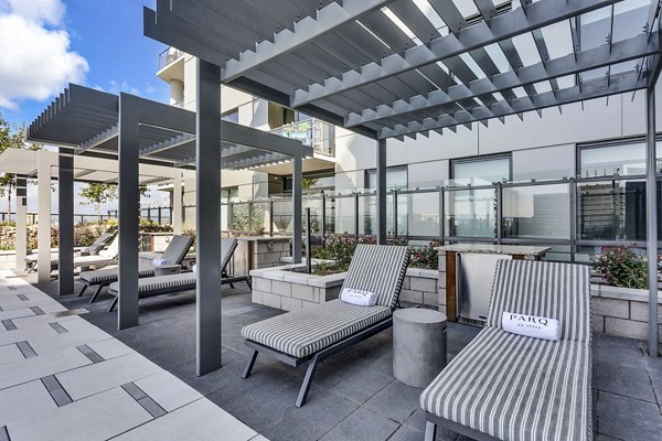 Outdoor lounge area with striped chairs and pergolas at Parq on Speer luxury apartments in downtown Denver