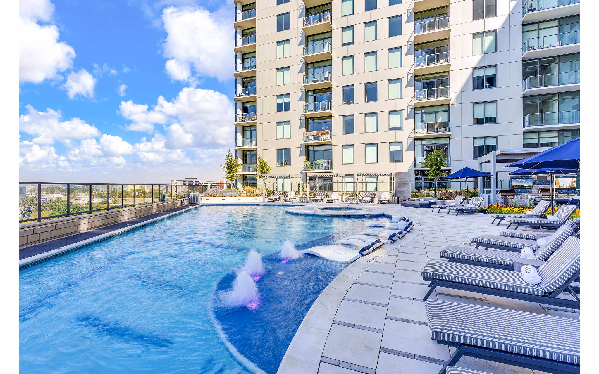 Parq on Speer Apartments: High-rise luxury apartments with outdoor pool and lounge chairs in the heart of the city