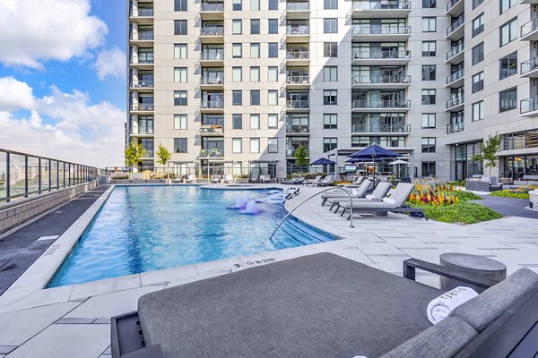 Outdoor pool area with lounge chairs at Parq on Speer Apartments in Denver, luxury modern living by Greystar