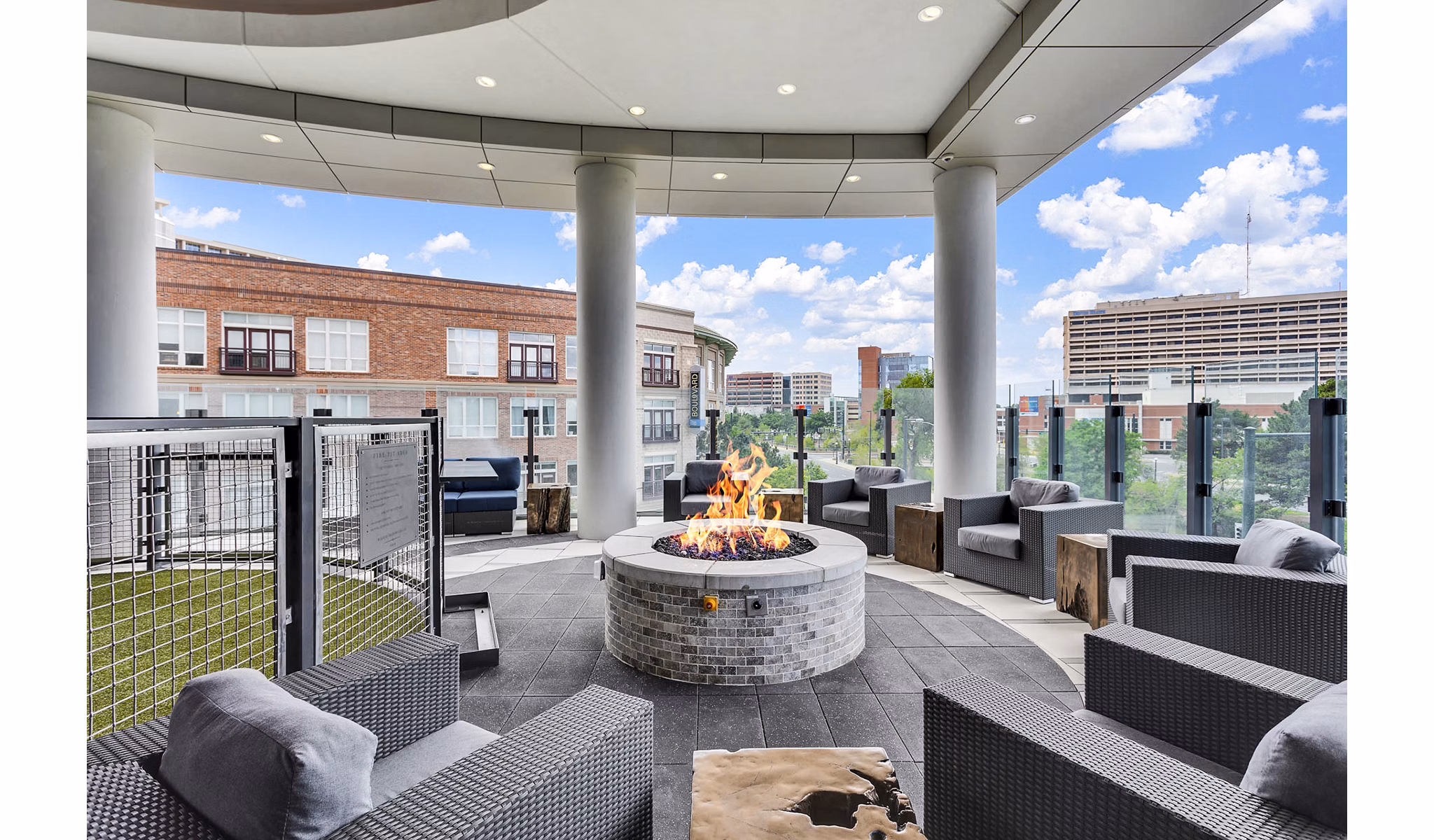 Outdoor lounge with fire pit and contemporary seating at Parq on Speer luxury apartments in downtown Denver