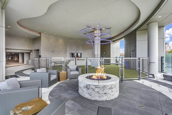 Outdoor lounge with fire pit and seating at Parq on Speer Apartments in Denver, offering luxury living by Greystar