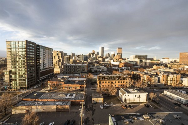 Parq on Speer Apartments: Aerial cityscape view with buildings under cloudy sky, highlighting luxury urban living in downtown Denver