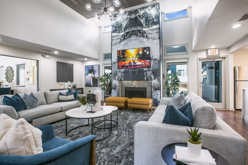 Clubhouse lobby with modern seating and artwork at AYA ABQ Apartments